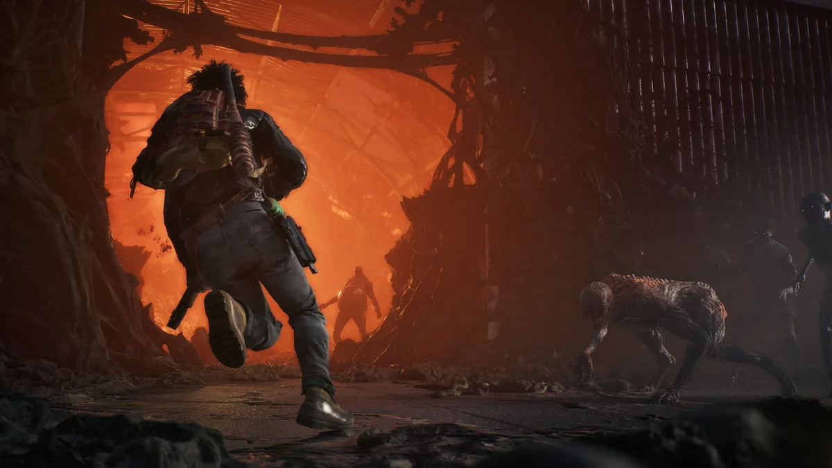 A survivor sprinting into an overgrown, infested structure glowing orange-red inside, with a plague-ridden creature nearby